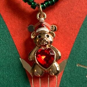 Sweet little Christmas bear necklace with red heart belly.
